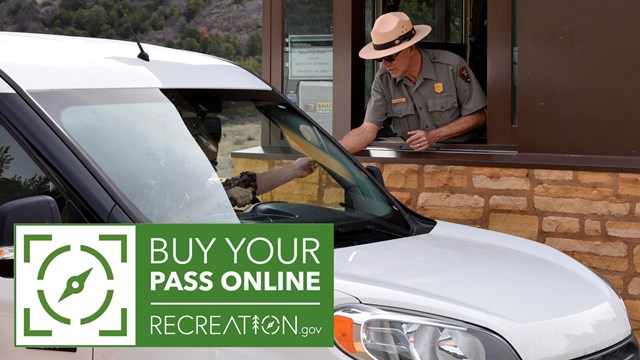 Green and white fee logo in left corner. Person in white car reaches toward the NPS ranger in booth 