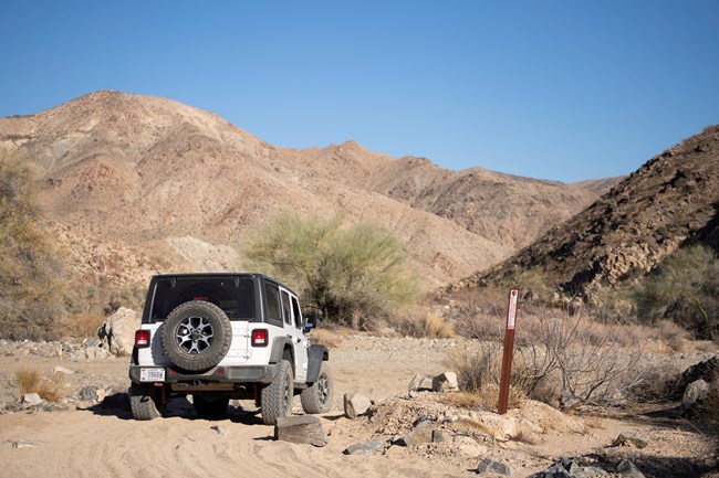 Jeep on dirt road with rocks